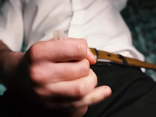 Sexy alms-man in a lodge jerks off close-up, moans with pleasure and cums in a condom.